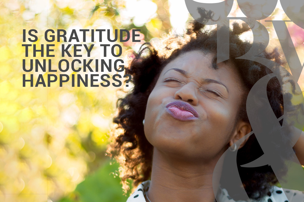 Happy woman thinking gratitude is the key to unlocking happiness